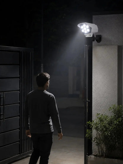 Lámpara solar de seguridad con sensor de movimiento tipo cámara, control remoto y soporte para exterior